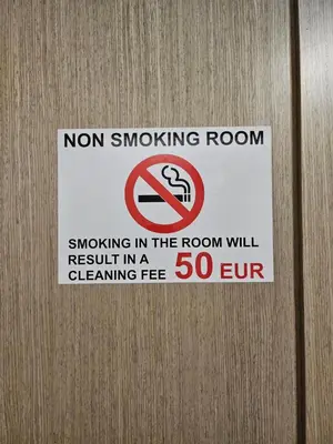 a sign on a door that says no smoking room at Kauno apartamentai in Kaunas