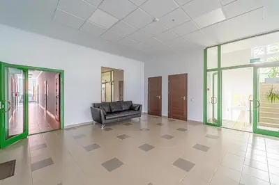 a black leather couch in a room with glass doors at Modern Loft Apartment w/free parking No.3 in Marijampolė
