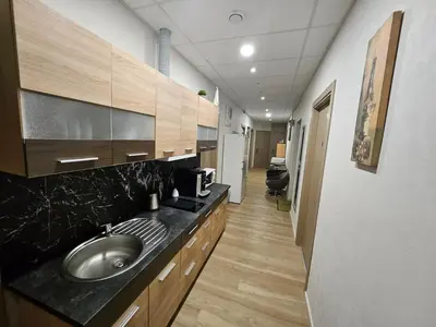 a large bathroom with a sink and a hallway at Kauno apartamentai king size bed in Kaunas