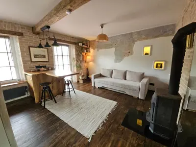 a living room with a couch and a table at Paupio Gertruda in Vilnius