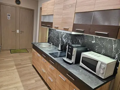 a kitchen with a microwave and a sink at Kauno Apartamentai in Kaunas