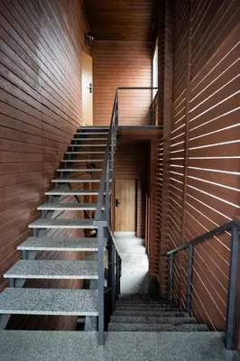 a staircase in a building with a wooden wall at Central Station Apartment No7 in Kaunas