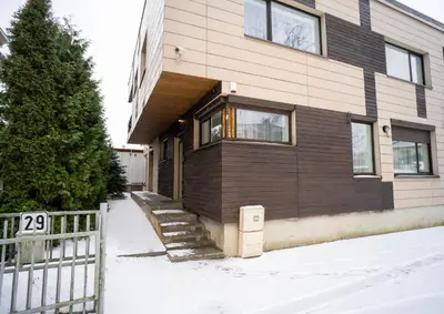 a house with a fence in front of it at Central Station Apartment No5 in Kaunas