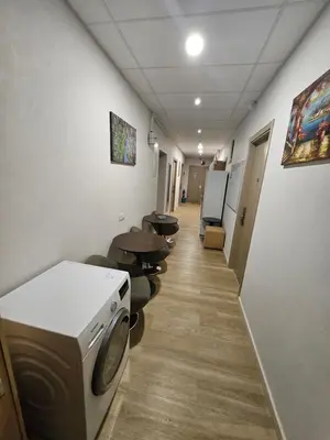 a hallway of a hospital with a washing machine at Kauno apartamentai big room king size bed in Kaunas