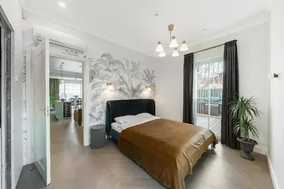 a bedroom with a bed and a large window at Vilnius legends house APARTMENT I Best for families I Free parking in Vilnius