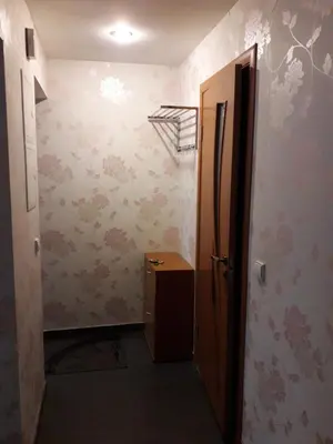a hallway with a door to a room with wallpaper at Butas su Jacuzzi in Kaunas