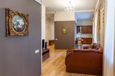 a living room with a couch and a painting on the wall at Central apartments 2 x Free Parking x SELF CHECK-IN 24h by H&H in Vilnius