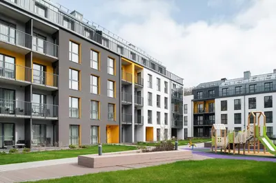 an apartment building with a playground in front of it at No. 2 PARK AVENUE APARTMENT in Kaunas