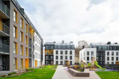 a group of buildings with a playground in the middle at No. 2 PARK AVENUE APARTMENT in Kaunas