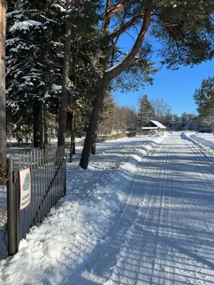 a snow covered road with trees and a fence at Vila Loreta - visas privatus namas in Dūdorynė