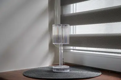 a glass vase sitting on a table next to a window at Great location STUDIO1 on the first floor, 24h self check-in in Kaunas