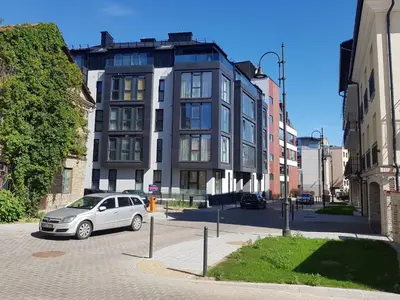 a car parked in a parking lot in front of a building at HaPPy iNN LUX Old Town Studio, Self Check in, Parking in Vilnius