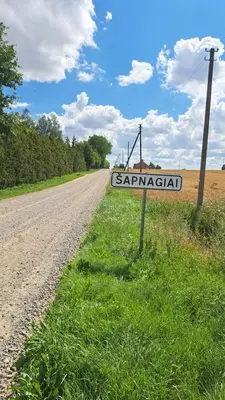 a street sign on the side of a road at Jaukaus buto nuoma Šiaulių rajone in Šapnagiai