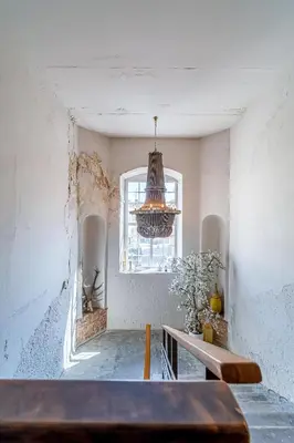 a room with a table and a window and a chandelier at Jazz Old Town apartment with AC in Kaunas