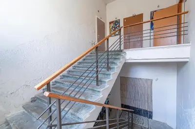 a staircase with a metal railing in a building at Serenade Old Town apartment with AC in Kaunas