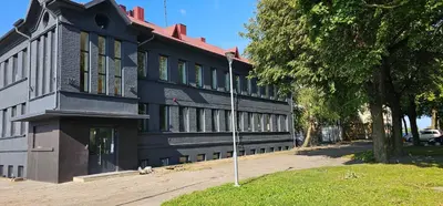a black building with a pole in front of it at Platforma2b eco in Šiauliai
