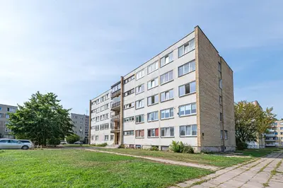 an apartment building on a street with a car parked in front at Pramones apartment #1 by PoloApartments in Kaunas