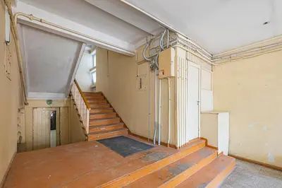 an empty room with a staircase in a building at Pramonės Apartment #6 by PoloApartments in Kaunas