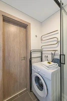 a washer and dryer in a laundry room at Pramonės Apartment #6 by PoloApartments in Kaunas