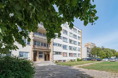 an apartment building with a sidewalk in front of it at Pramonės Apartment #7 by PoloApartments in Kaunas