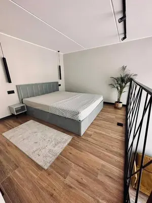a bedroom with a large bed in a room at Sunny loft 24x7 x free parking x close to old town by H&H in Vilnius