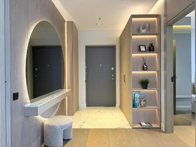 a hallway with a door and a stool and a mirror at Apartment near Hospital Kaunas Clinics in Kaunas