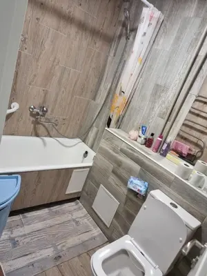 a bathroom with a toilet and a sink and a tub at Kaunas 174 in Kaunas
