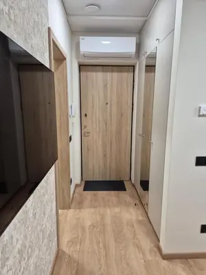 a hallway with a wooden door in a building at New Kreves apartment & Free parking & Self check-in in Kaunas
