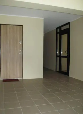 an empty room with a door and a tiled floor at Mini Studio Apartment in Kaunas