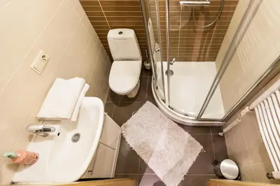 a small bathroom with a toilet and a sink at Central apartments 1 x Free parking x Self Check in in Vilnius