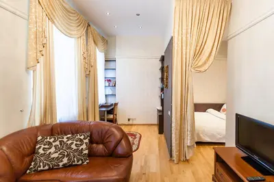 a living room with a couch and a bed at Central apartments 1 x Free parking x Self Check in in Vilnius