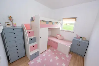 a childs bedroom with a bunk bed and a dresser at Poilsio oazė in Panevėžys