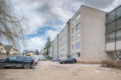 a parking lot with cars parked in front of a building at Studio apartment Sea by PoloApartments in Kaunas