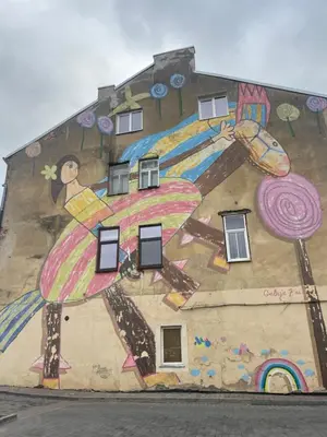 a building with a painting on the side of it at MM Apartments in Kaunas