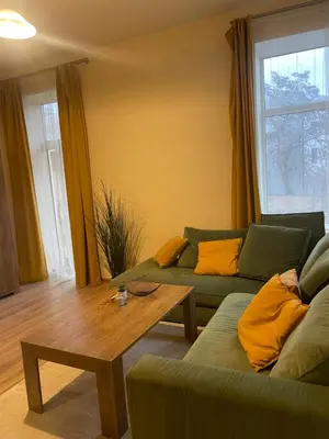 a living room with two couches and a coffee table at MM Apartments in Kaunas
