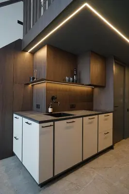 a kitchen with white cabinets and a sink at K32 Loft in Vilnius