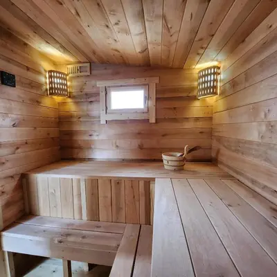 an inside of a wooden sauna with a bench at Vipoilsis Namelis N3 in Čekoniškės