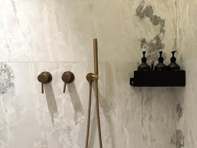 a wall with a shelf with bottles on it at Žaliakalnis Luxury Suites in Kaunas