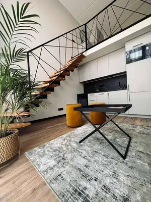 a room with a table and chairs and a staircase at Sunny loft 3 x 24x7 x Close to old town in Vilnius
