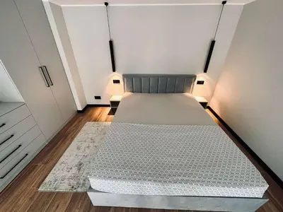 a large bed in a room with white walls at Sunny loft 3 x 24x7 x Close to old town in Vilnius