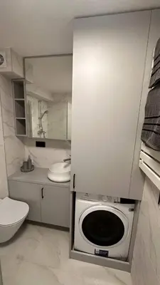 a kitchen with a washing machine in a bathroom at Sunny loft 3 x 24x7 x Close to old town in Vilnius