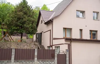 a house with a fence in front of it at Compact and Comfy Apartment on the Greenhill in Kaunas
