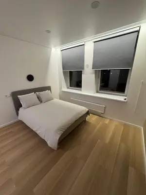a bedroom with a bed and a large window at 5 New Airport Apartment in VNO
