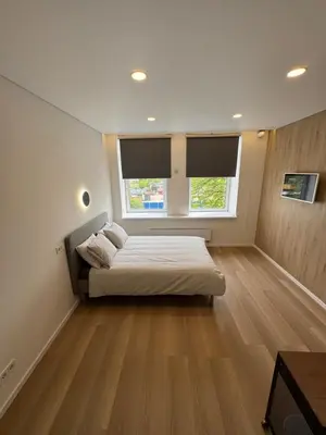 a large bedroom with a bed and a window at 6 New Airport Apartment in VNO