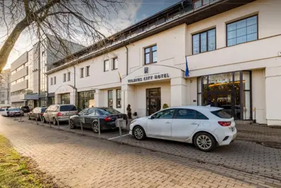 a white car parked in front of a building at Naujamiescio Studio in Vilnius