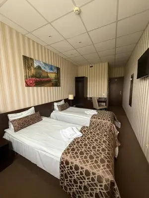 a hotel room with two beds and a television at Naujamiescio Studio in Vilnius
