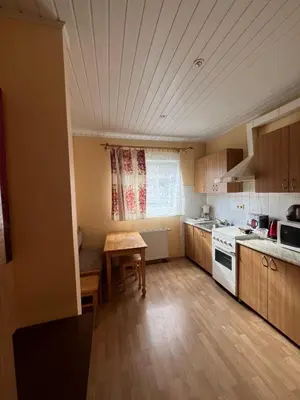 a small kitchen with a table and a stove at Cozy Maumedziu apartment in Vilnius