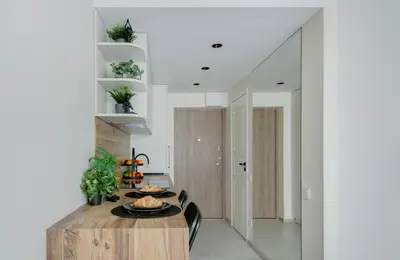 a dining room with a table with plates of food on it at Green Apartment in Vilnius