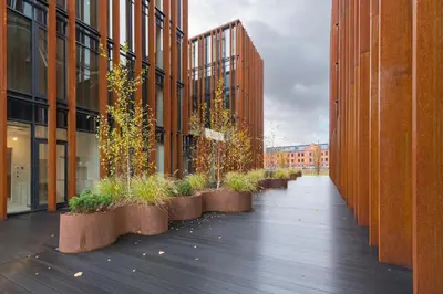 a walkway between two buildings with potted plants at Comfortable 2 BD Apartment by Domvia in Kaunas
