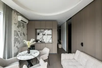 a living room with a table and white chairs at Sky&River Towe Apartments Kaunas City Center in Kaunas